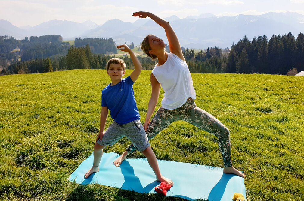 Aktiv sein mit der Yogaübung Friedvolle Krieger im Kinderhotel Allgäuer Berghof