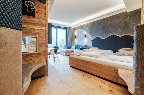 Kinderhotel Allgäuer Berghof – Wohnzimmer der Familien-Suite Spass-Suite mit Blick auf die Allgäuer Alpen