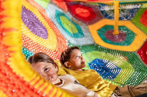 Teenager im Kletternetz in der Spielscheune im Kinderhotel Allgäuer Berghof